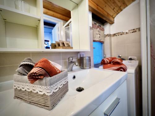 a bathroom with a sink and a washing machine at DIMORA DELLA GALERA (ACQUARIO) - GENOVABNB it in Genova