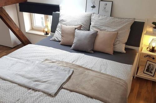 a bed with pillows on it in a bedroom at Kempten - Lebendig und voller Geschichte in Kempten