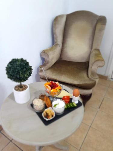 a tray of food on a table next to a chair at Elizabeth Suites in Kato Daratso