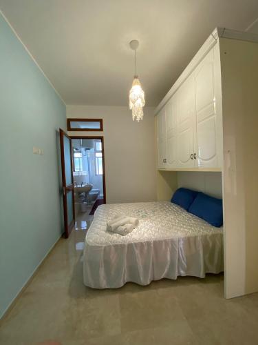 a bedroom with a bed and a chandelier at Il Mare in Tasca - Casa Vacanze - loc.Torre Lapillo (LE) - Salento in Torre Lapillo