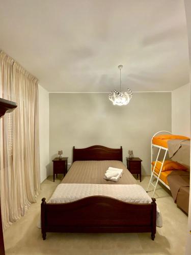 a bedroom with a bed and a chandelier at Il Mare in Tasca - Casa Vacanze - loc.Torre Lapillo (LE) - Salento in Torre Lapillo