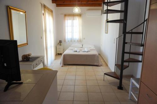 a bedroom with a bed and a television in a room at Agapi Holiday Home in Rethymno