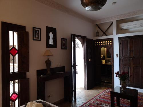 a living room with a door open to a room at Riad Charme d'Orient Adults Only in Marrakech