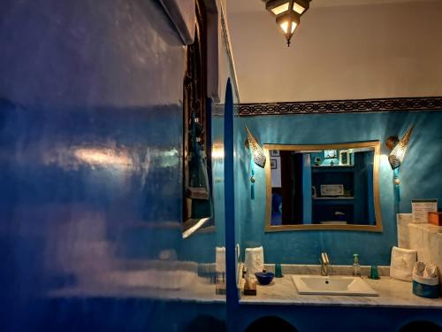 a bathroom with a sink and a mirror at Riad Charme d'Orient Adults Only in Marrakech