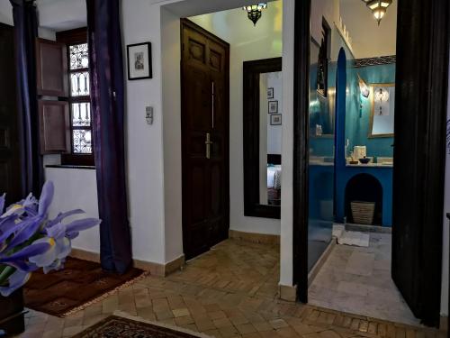 a hallway with a door and a mirror at Riad Charme d'Orient Adults Only in Marrakech