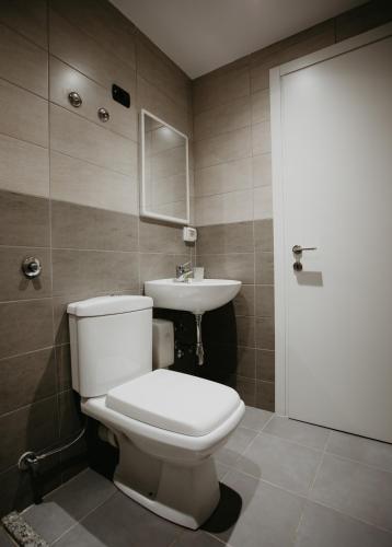 a bathroom with a toilet and a sink at Hotel Miki in Durrës