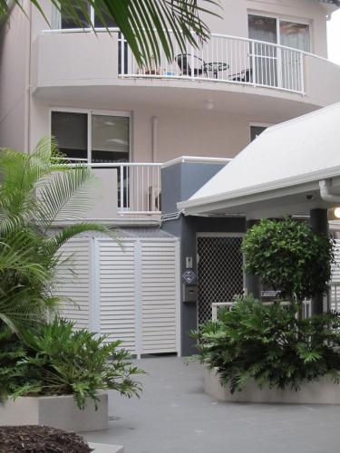 a house with a white fence in front of it at Costa D'Ora Holiday Apartments in Gold Coast