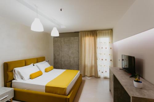a bedroom with a large bed and a television at Hotel Miki in Durrës
