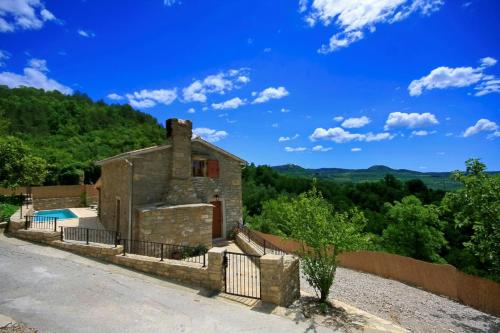 an old stone house with a swimming pool and a fence at Villa Alba in Livade