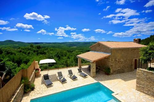 a villa with a swimming pool and lounge chairs at Villa Alba in Livade