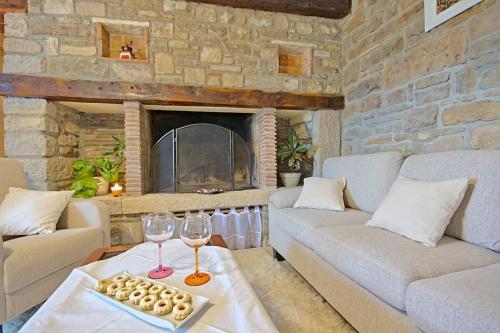 a living room with a couch and a fireplace at Villa Alba in Livade
