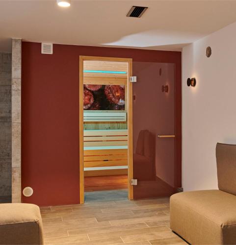 a living room with a door leading into a room at Cavallestro Deluxe in Kitzingen