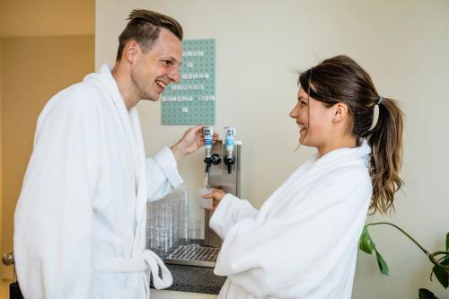 a man and a woman standing in a room at Hotel Gasthof Ochsen in Kißlegg