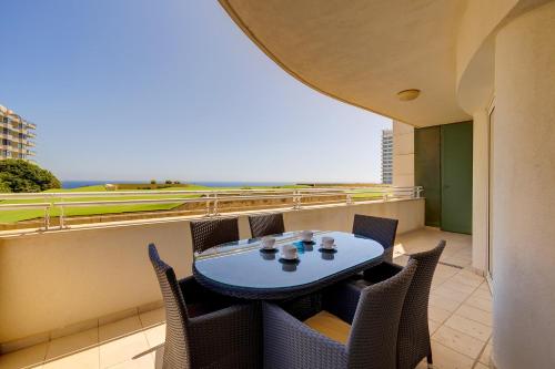 a patio with a table and chairs on a balcony at SEAFRONT LUX APART inc POOL, Upmarket Area in Sliema