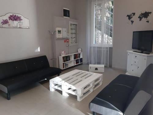 a living room with a couch and a coffee table at Ostello Verbania in Verbania