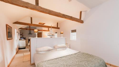 a bedroom with a white bed with two pillows at Partridge Lodge Self Catering houses in Woodbridge