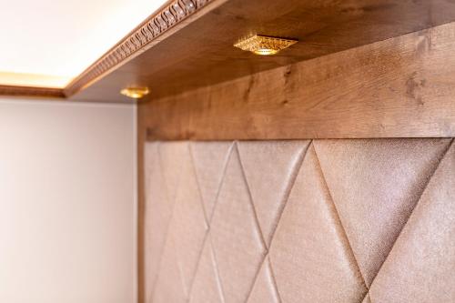 a wall with a metal door in a room at Strass - Sport & Spa Hotel in Mayrhofen