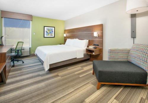 a hotel room with a bed and a desk and a chair at Holiday Inn Express - Hope by IHG in Hope