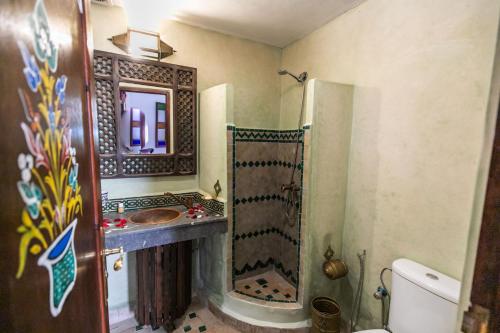 a bathroom with a shower and a sink at Riad Jardin Chrifa in Fès