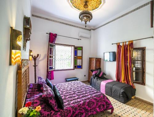 a bedroom with two beds and a window at Riad Jardin Chrifa in Fès