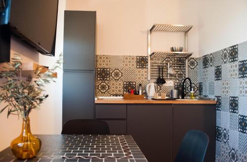 a kitchen with a table and a counter top at Kiwi Studio in Opatija