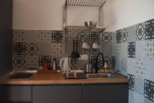 a kitchen with a sink and a counter top at Kiwi Studio in Opatija