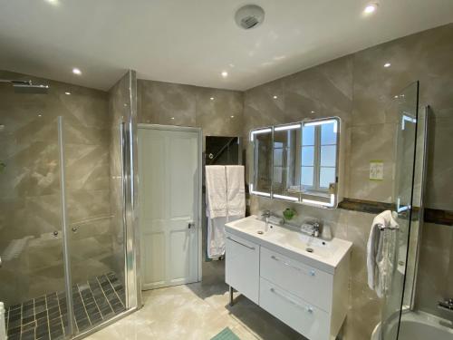 a bathroom with a shower and a sink and a shower at DDay Aviators Le Manoir in Arromanches-les-Bains