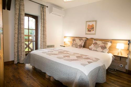 a bedroom with a bed and a window at La Ferme du Cayla in Linac