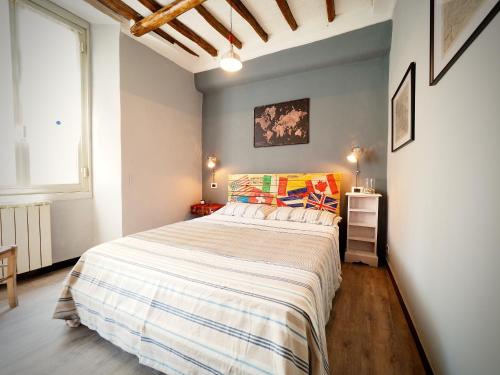 a bedroom with a large bed and a window at DIMORA DEL CARMINE ACQUARIO - GENOVABNB it in Genova