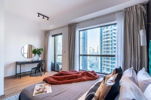 a bedroom with a large window and a bed at The Smart Concierge - Bahar 6 in Dubai