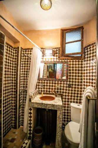 a bathroom with a sink and a toilet in it at Riad Jardin Chrifa in Fès