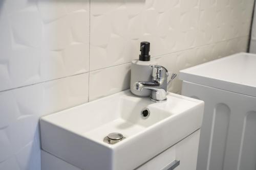 a white bathroom sink with a faucet on it at Holiday Home Relax - Mošćenička Draga in Mošćenička Draga
