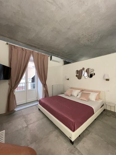 a bedroom with a large bed with a red blanket at Casta Diva Luxury Apartments -Self check-in in Palermo