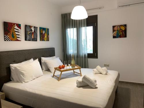 a bedroom with a bed with a table on it at Angela Apartments in Kato Daratso