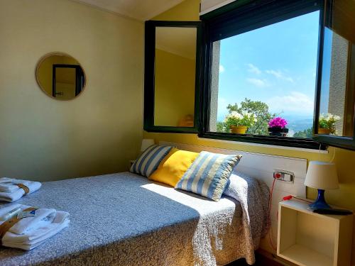 a bedroom with a bed and a window with a view at Sleeping Sarria Hostel in Sarria