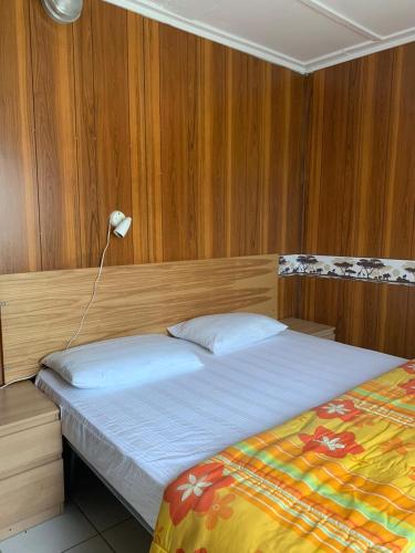 a bedroom with a bed and a lamp in it at Maronda Camping in Marina di Montenero