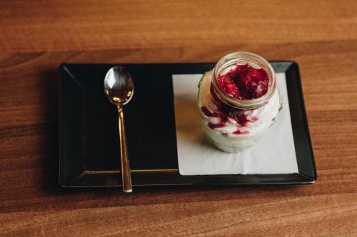 a spoon sitting next to a jar of dessert at Ribarski konaci in Doboj