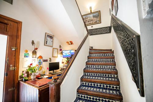 a staircase leading up to a home office with a desk at Riad Jardin Chrifa in Fès