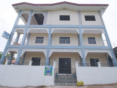 a white building with a white wall at OYO 781 Junie Pension House in Moalboal