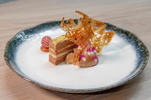 a plate with a piece of cake on a table at Horwood House Hotel in Milton Keynes