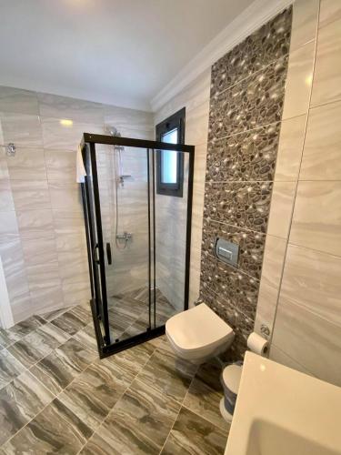 a bathroom with a shower and a toilet at Cilek Butik Hotel in Cesme