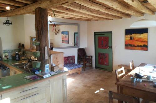 a kitchen with a counter and a table in a room at Maison traditionnelle briançonnaise in Briançon