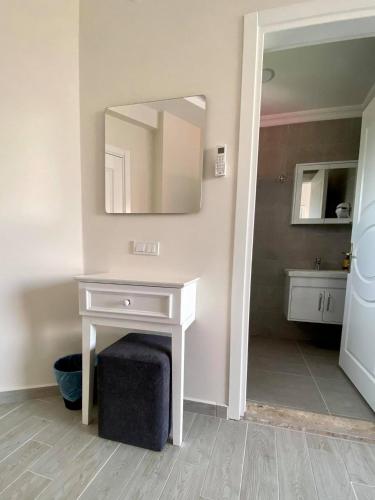 a bathroom with a white vanity and a mirror at Cilek Butik Hotel in Cesme