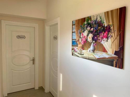 a room with a vase of flowers on a table at Cilek Butik Hotel in Cesme