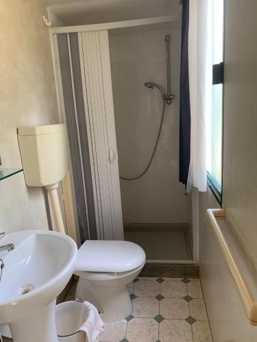 a bathroom with a sink and a toilet and a shower at Maronda Camping in Marina di Montenero