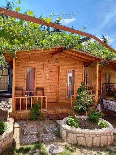 a wooden cabin with a porch and a patio at Cilek Butik Hotel in Cesme