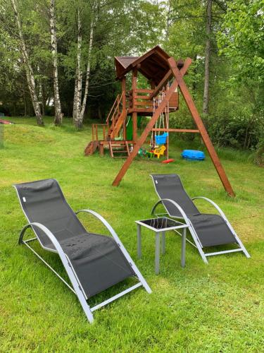 two chairs and a table and a play house at Mezná 85 in Hřensko
