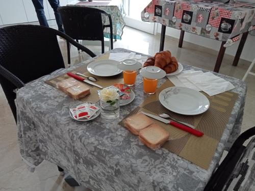 a table with plates of food and drinks on it at B&B Villa Bello in Otranto