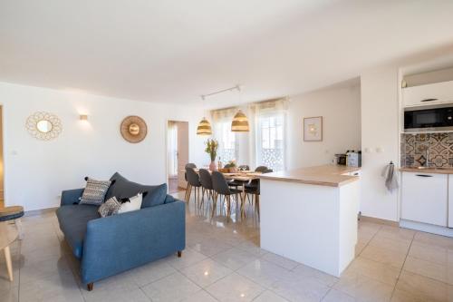 a kitchen and living room with a couch and a table at Le Duplex - Disneyland - Rooftop - Wifi in Montévrain