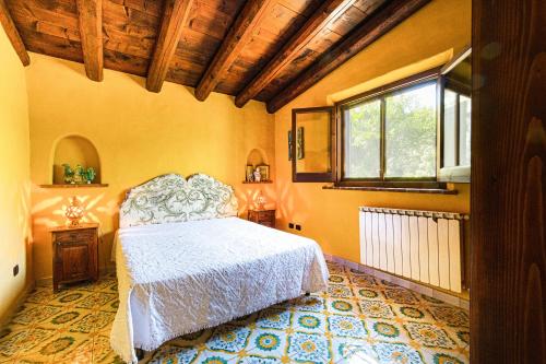 a bedroom with a white bed and a window at Villa Fratantoni Piana - Villa privata con accesso diretto alla spiaggia in Caronia Marina